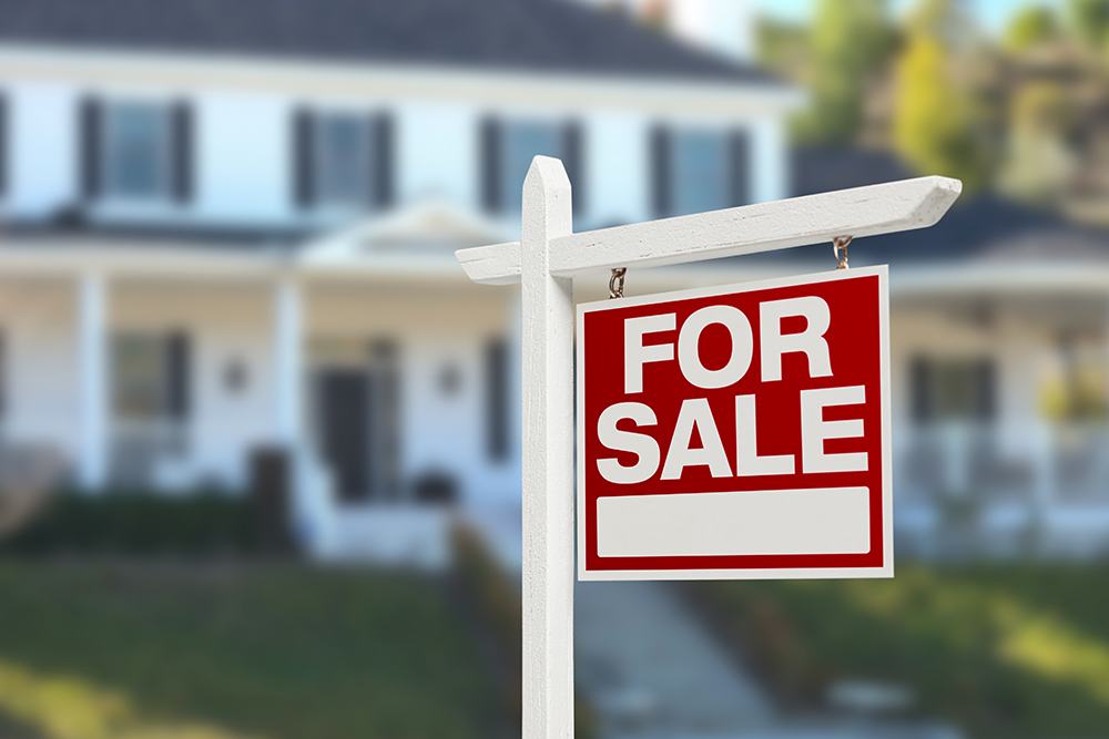 For sale sign in front of a house after thorough home inspection services were provided